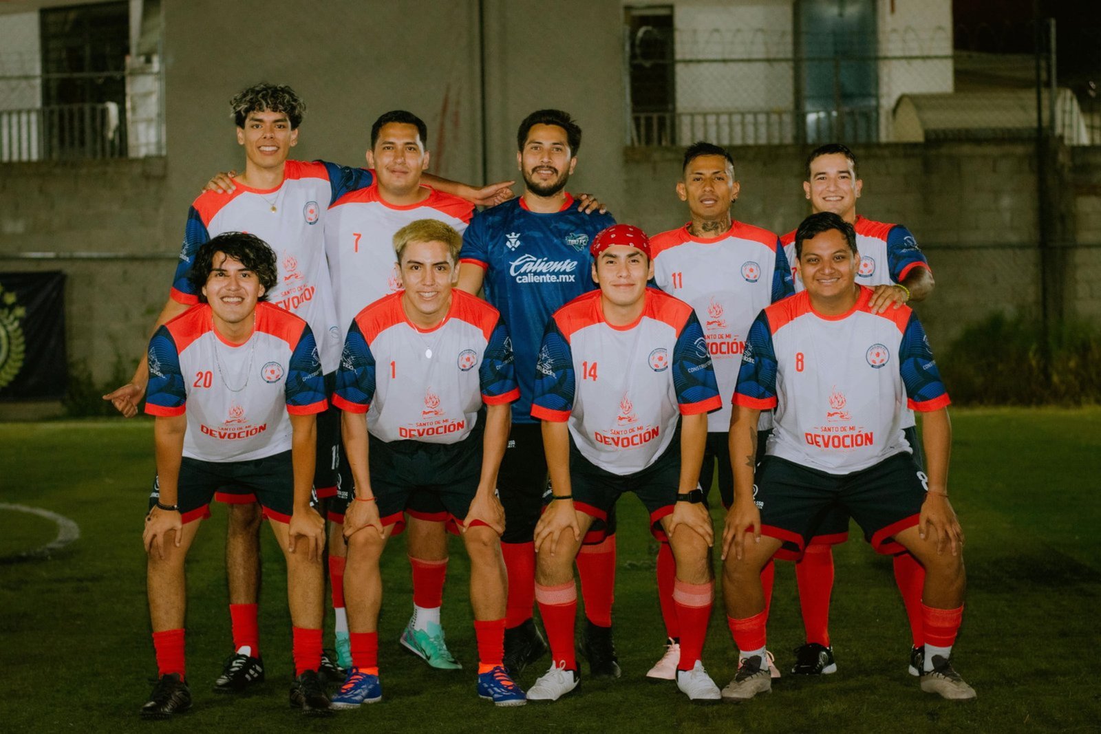 Soccer players wearing custom team jerseys on the field -- JuHong SPORTS uniforms